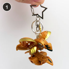 #1 Rosegold Brawler upcycled Bakugan keychain, opened